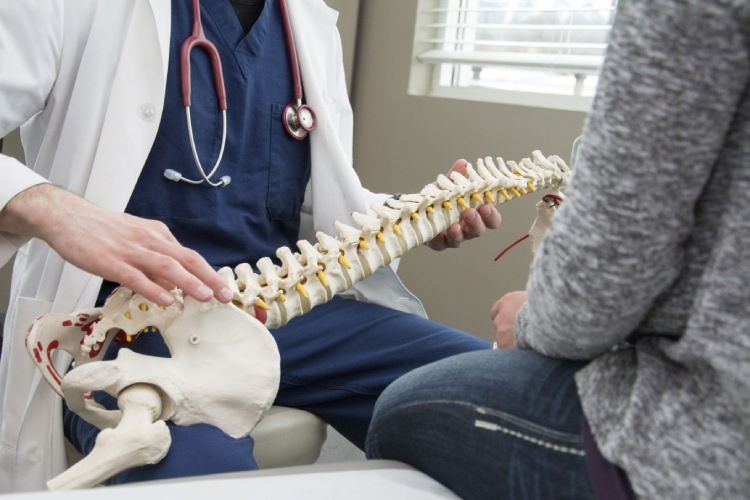A-doctor-helps-with-back-surgery-prep.jpg