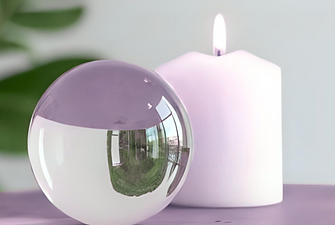 Crystal ball beside lit candle