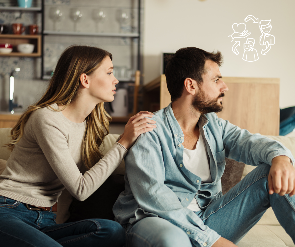 Woman consoles man on couch, touching his shoulder. Thought bubble with relationship diagram above. Kitchen background, neutral tones.
