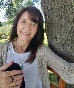 Smiling woman, Psychic Medium, outdoors by tree