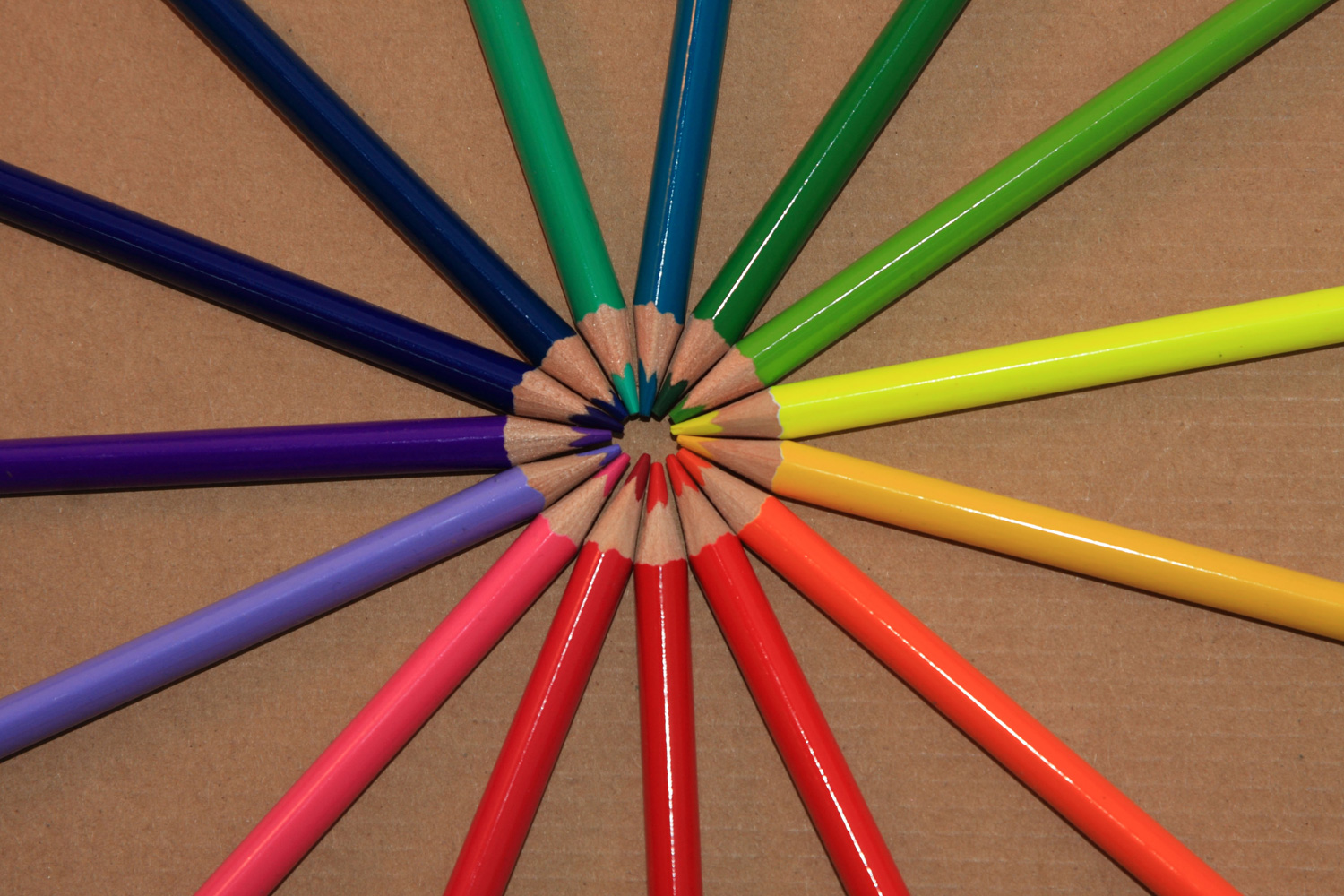 Circle of Colored Pencils Beige Background