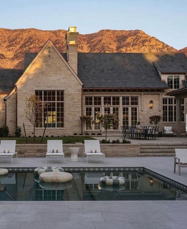 super-high, steeply-sloped roofs, sloped rooflines, floor-to-ceiling windows with delicate grids, and decorative gable vents