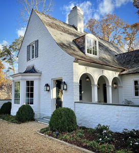super-high, steeply-sloped roofs, sloped rooflines, floor-to-ceiling windows with delicate grids, and decorative gable vents