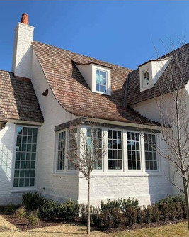 super-high, steeply-sloped roofs, sloped rooflines, floor-to-ceiling windows with delicate grids, and decorative gable vents