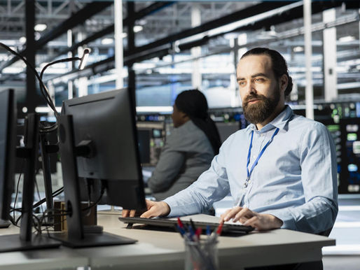 man sitting confidently at his desk
