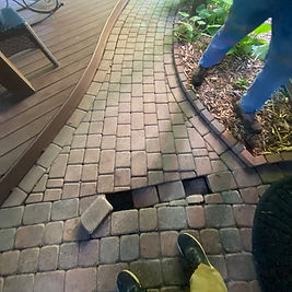 Repairing problematic areas by excavating the area, and rebuilding the surface before replacing the missing brick