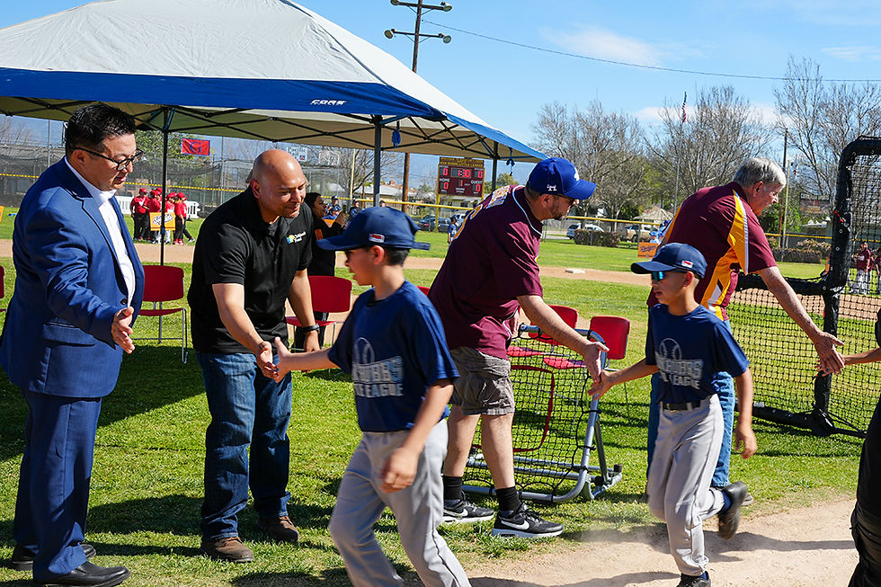 Cesar Navarrete greets players of Ken Hubbs Little League