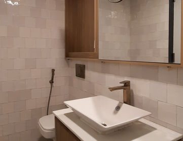 Modern bathroom interior with sink, toilet, and wooden vanity