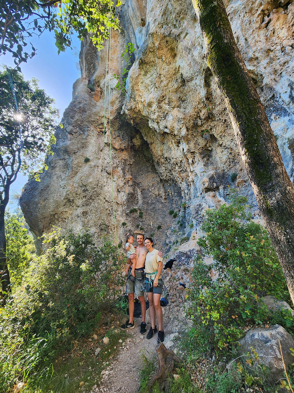 mum and dad holding their baby out climbing in the mountains in turkey