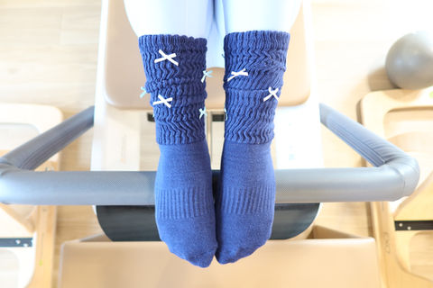 Lady displaying socks in pilates studio
