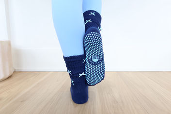 Lady displaying socks in pilates studio