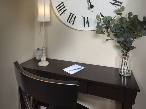 Desk with clock and lamp in an Asheville Cottage New Site.