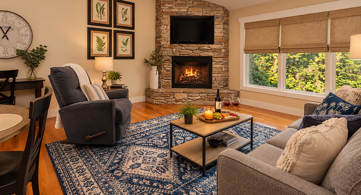 Cozy living room with stone fireplace and blue rug