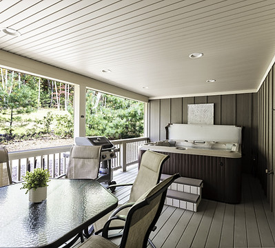 Hot tub and gas grill with dining table and chairs