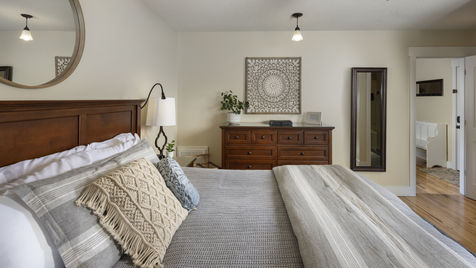 Bedroom at The Ivy Cottage with wood bed frame and dresser