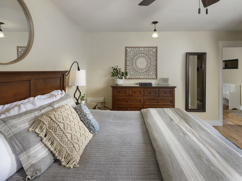 Bedroom at The Ivy Cottage with wood bed frame and dresser