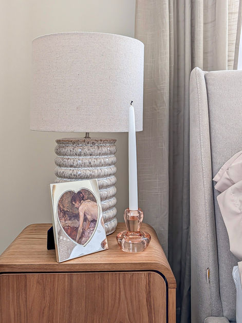 Wood bedside table styled with sculptural lamp and framed photograph in a classic London period flat.