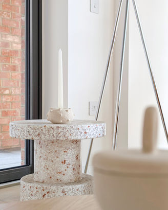 Contemporary London apartment styling with terrazzo side table, minimalist ceramic décor and soft neutral palette in luxury staged living space.