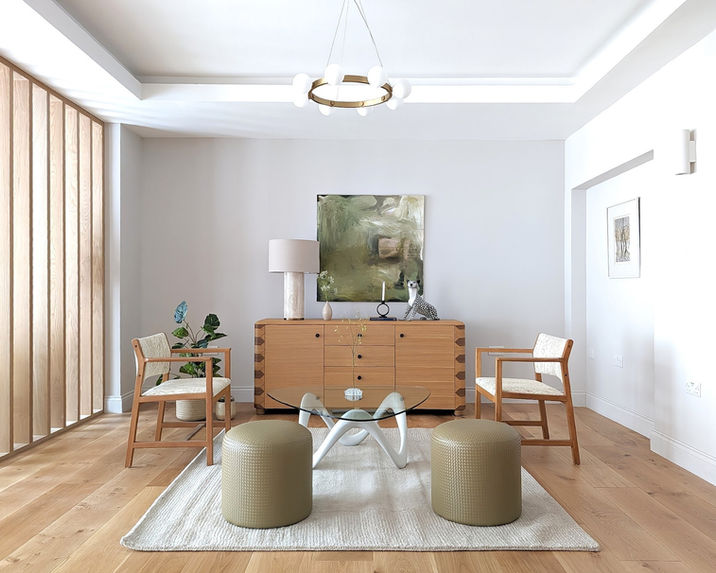 Bright London home staging living area with wood slat feature wall and sculptural coffee table.