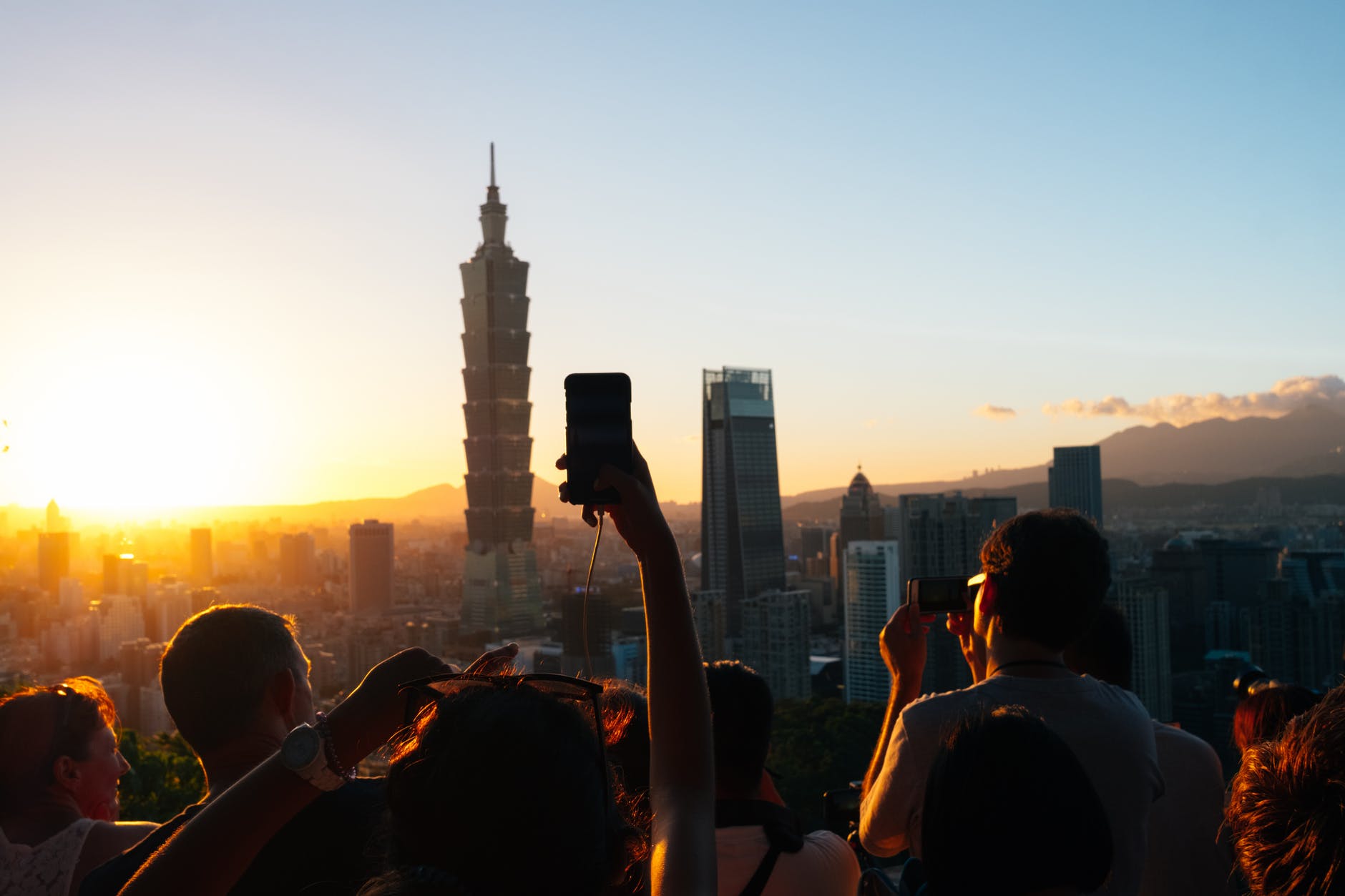 people taking photos of high rise buildings