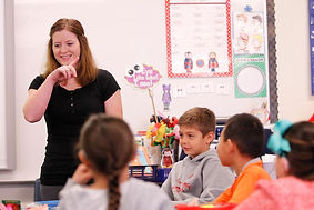 ASL american sign language educator teacher in classroom with young children