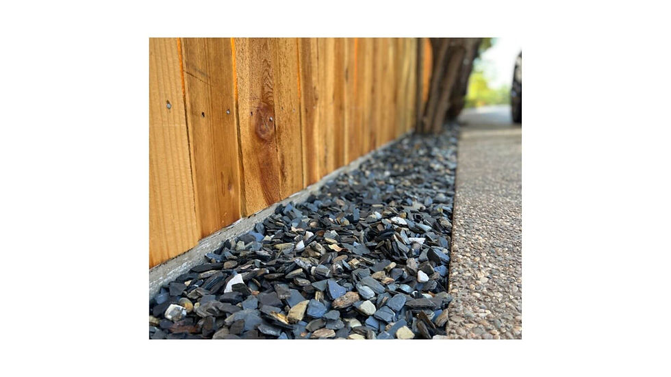 Thumbnail: Sonoma Slate Chip installed along a wooden fence and concrete edge; used as a decorative rock mulch solution in Petaluma
