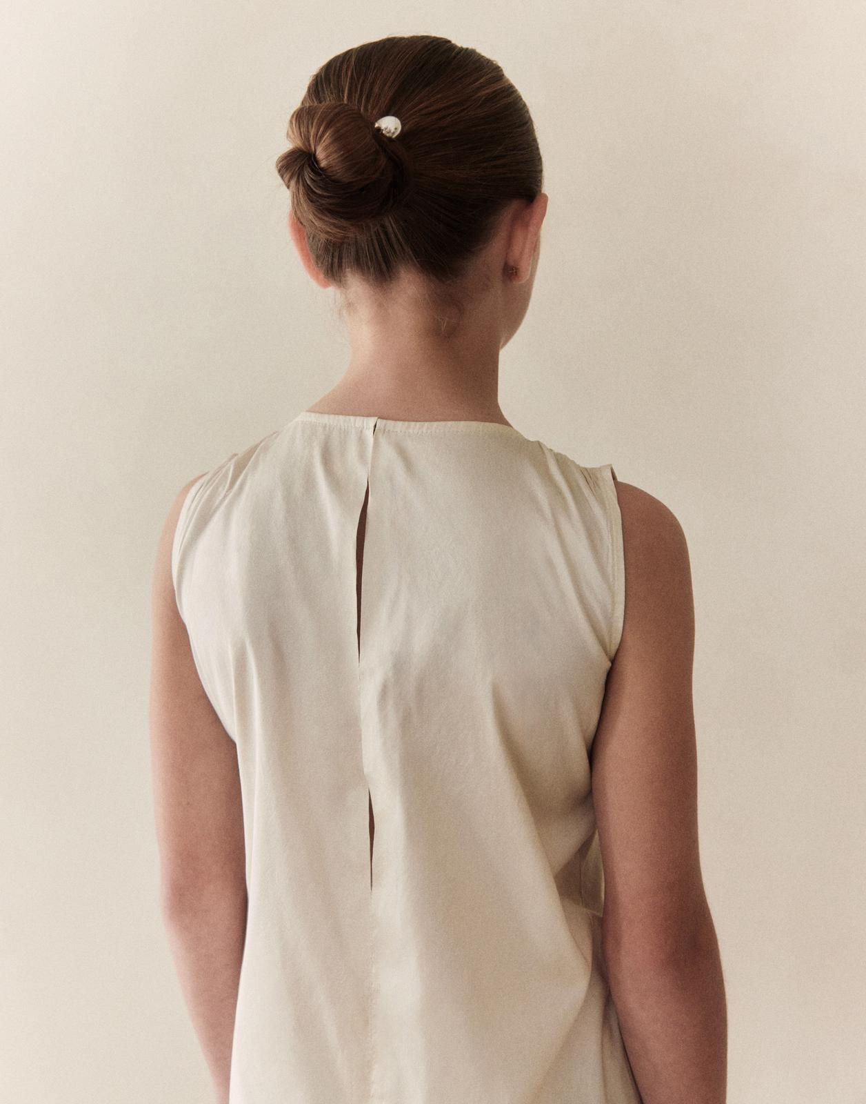 Daphne dress back view with pearl hair bun — styled by Ciara Aloisio
