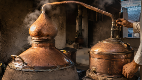 traditional copper attar distillation vessels in a Kannauj-style workshop