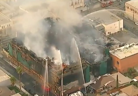 Fire trucks spraying water on the building