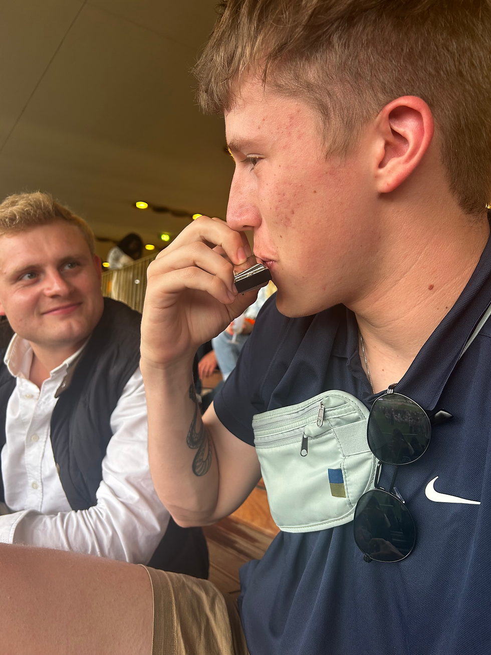 David playing a harmonica in-between races??