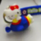 Cute Hello Kitty 3D keychain in a blue airplane with a matching strap.