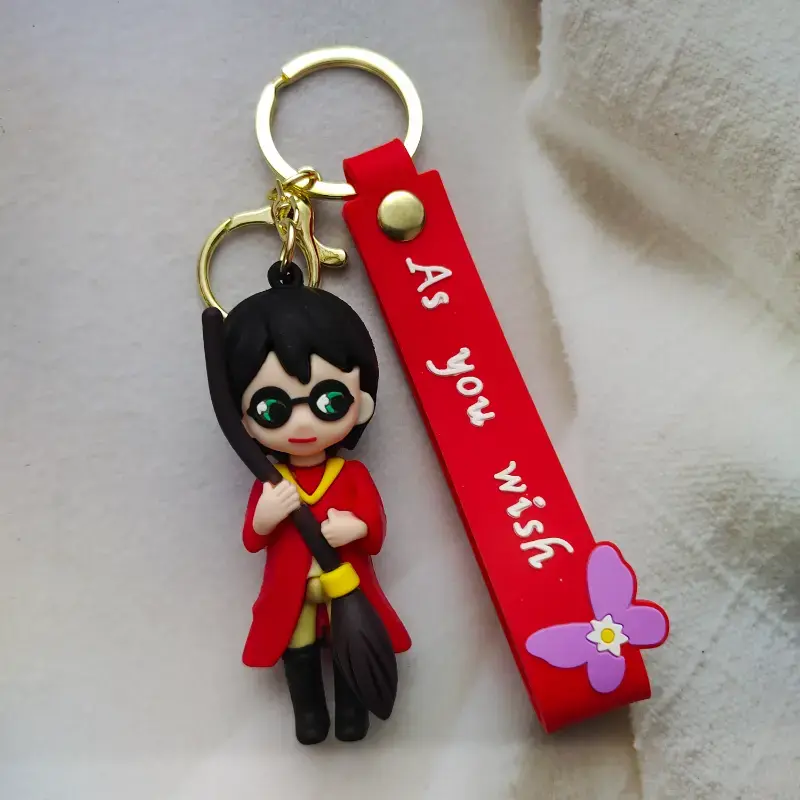 Harry Potter 3D Keychain in red uniform holding broomstick, premium collectible.