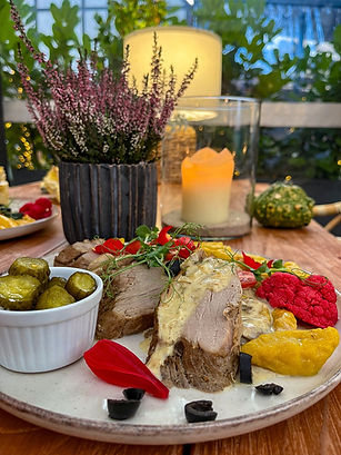 Apetyczny plater z polędwiczką, piklami, warzywami i świeżym wrzosem.