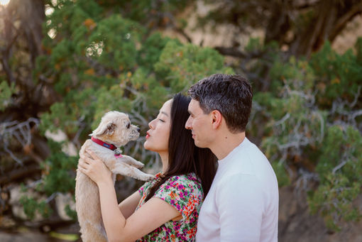 Expecting couple holding their dog during a Joshua Tree maternity session.