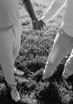 Black and white detail of an engaged couple holding hands during their Catalina Island engagement photos.