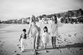 Black and white photo of a family of five walking with their mom along the shoreline during fall mini sessions at Crystal Cove.
