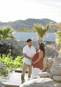 Near Palm Springs. Maternity photo of pregnant couple standing in a freshwater pond at Kaleidoscope Desert Animal Sanctuary in Morongo Valley
