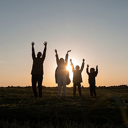 family-silhouettes-having-fun-sunset-full-shot-2.jpg