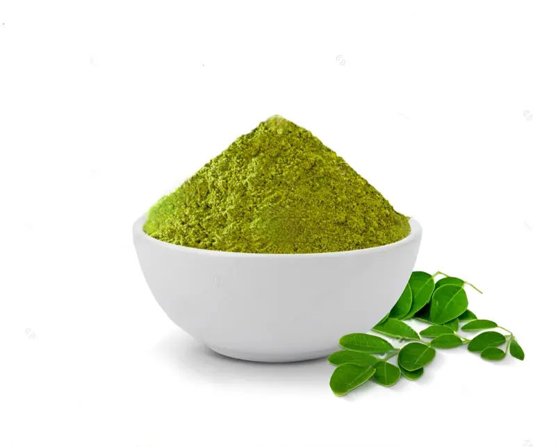 A white bowl  filled with Nature's Elements Moringa Powder along with few moringa leaves white background
