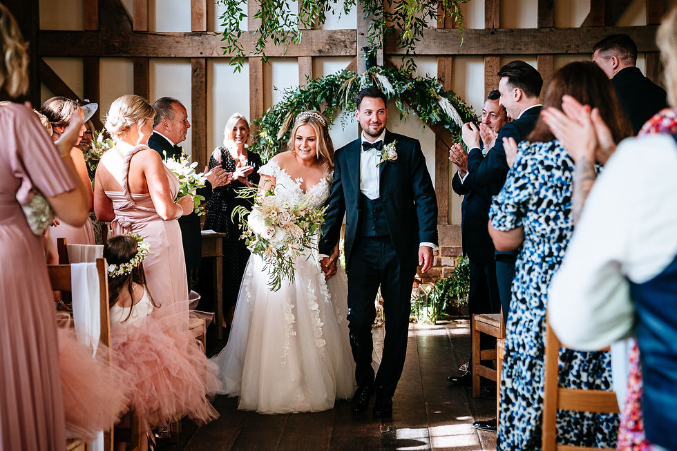 A Kent wedding couple walking down the aisle at Gate Street Barn in Surrey.