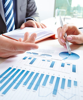 businessman-pointing-at-document-while-discussing-it-with-colleague-at-meeting-SBI-3007396