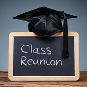 Black graduation hat on top of a chalkboard that says class reunion 