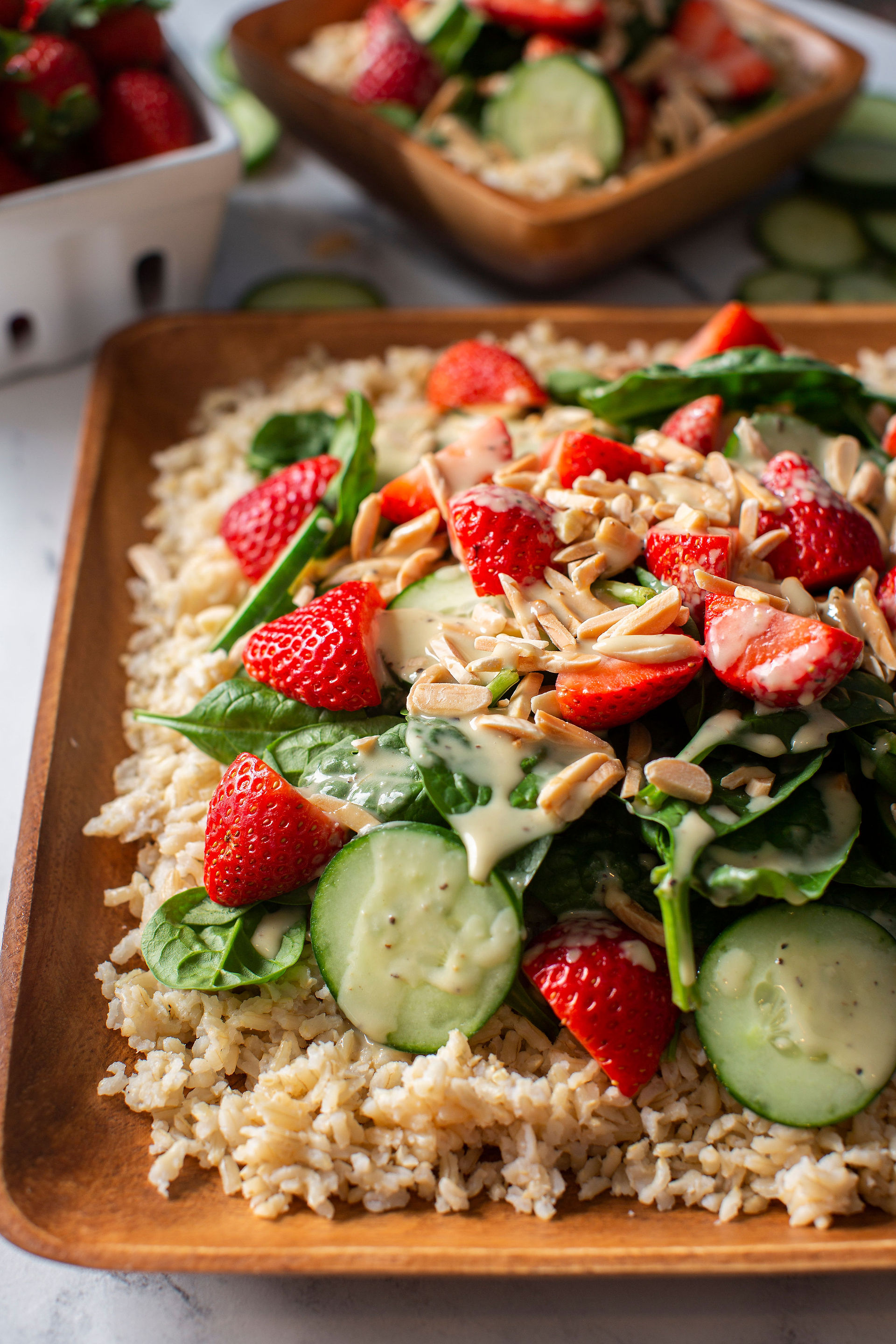 Brown rice salad with spinach, strawberries, cucumber, nuts