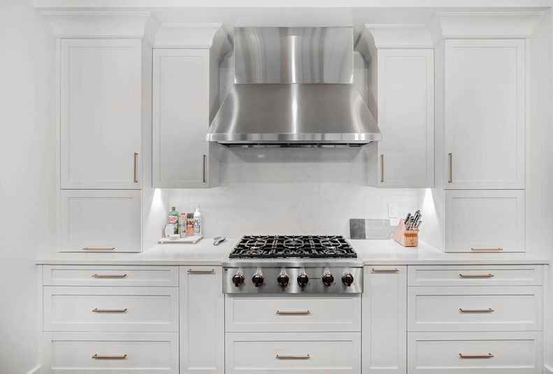VOGO Cabinets white Shaker cabinets, tall custom cabinets, and brass pulls built for a Denver home