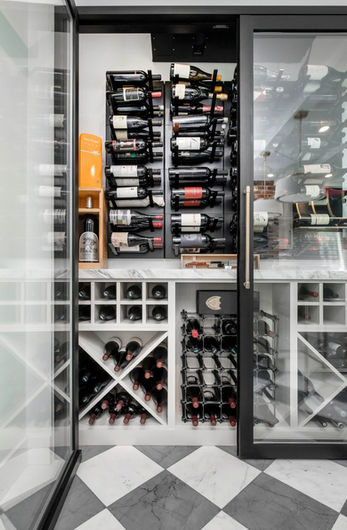 Contemporary wine storage nook with custom racks and bottle cubbies, crafted for a Denver home by VOGO Cabinets