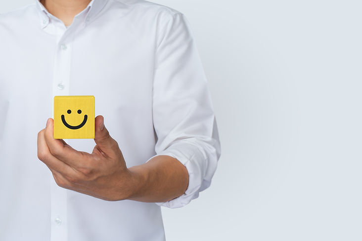 Hand of client show a feedback with smile face wood cube. Service rating, satisfaction con