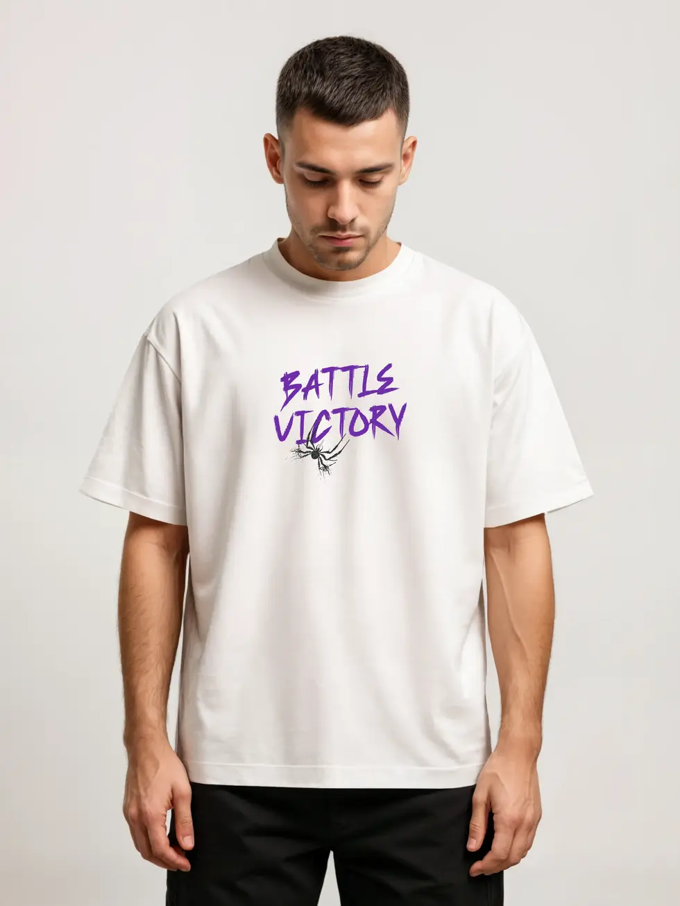 Model Wearing White oversized t-shirt with purple graffiti text “Battle Victory” and black spider sketch below