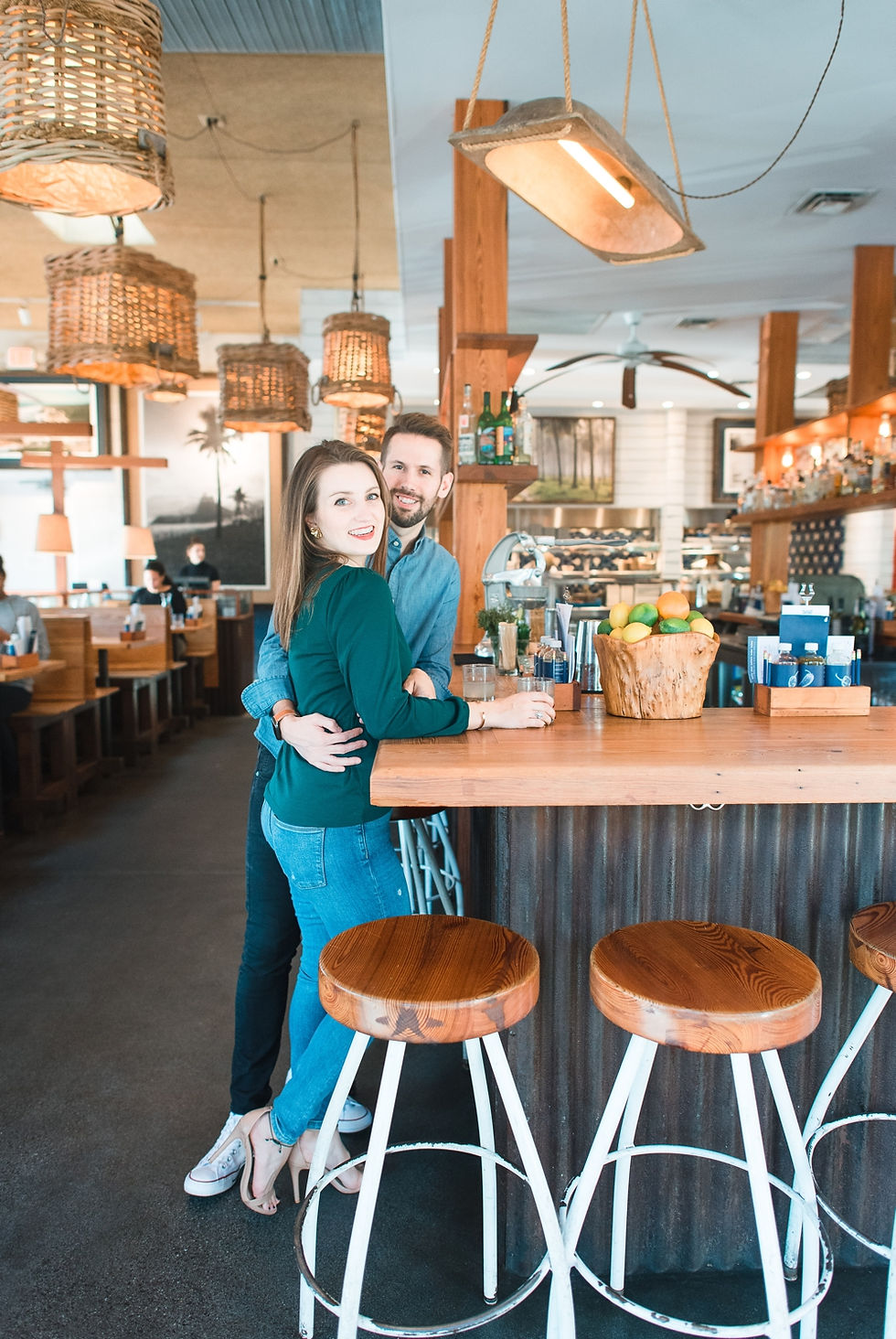 engagement session at westside provisions atlanta woman wearing yellow skirt and guy wearing maroon jeans