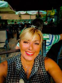 Smiling Helena at an outdoor cafe