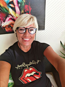 Helena smiling with short blonde hair and glasses